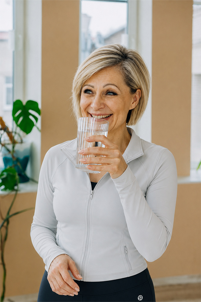 Woman drinking water during a wellness routine